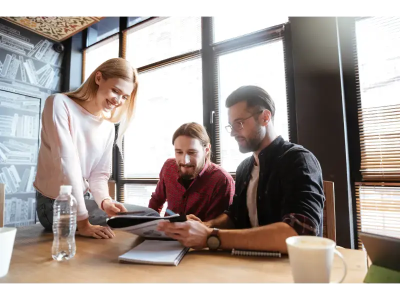 smiling-colleagues-sitting-office-coworking
